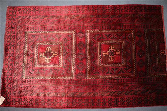 A Belouchi red ground rug, 4ft 11in by 2ft 1in.